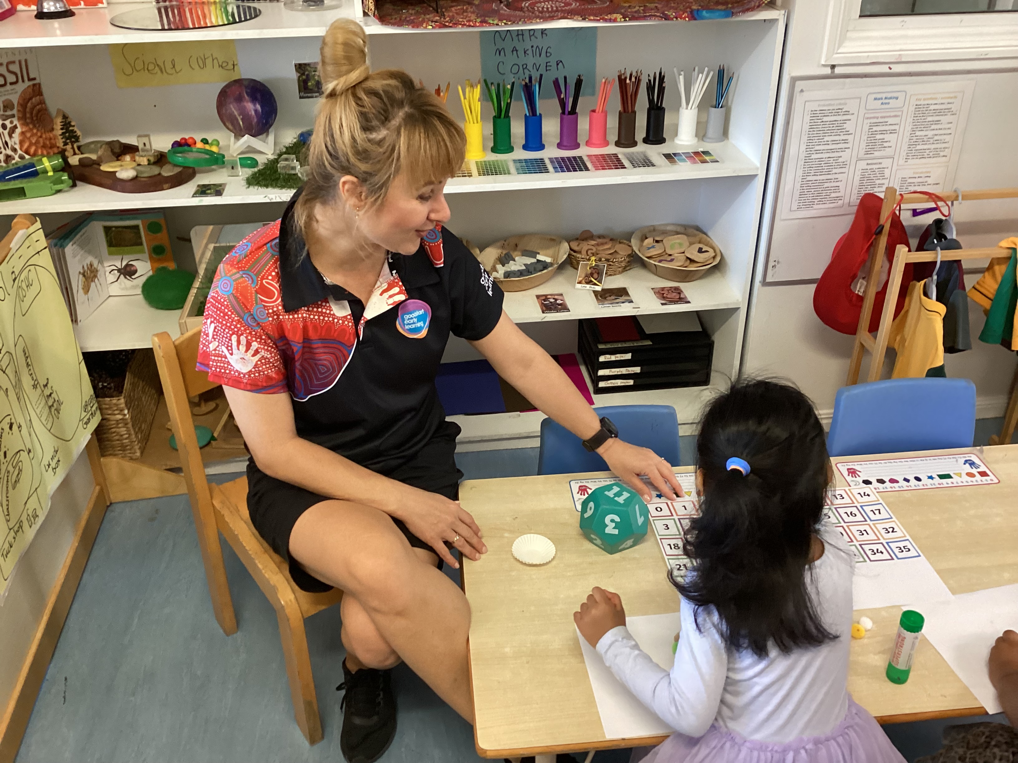 Early Childhood Teacher Daisy and a student at her centre in McDowall