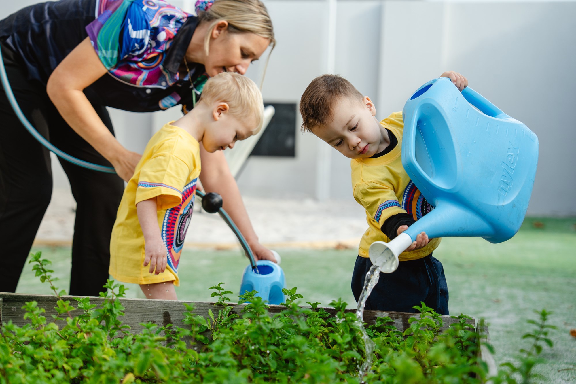 Goodstart-Huntingdale-Child-watering-garden.jpg